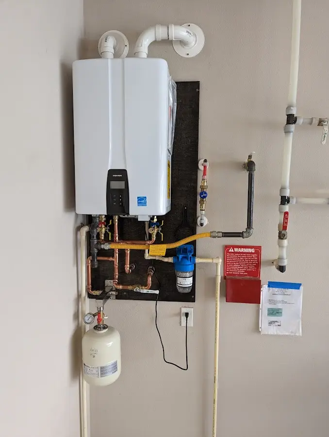 Professional plumber installing copper piping in a Marilla home